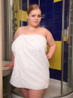 Naughty chubby girl posing naked in the showers
