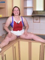 Sexy young plump stripping on kitchen