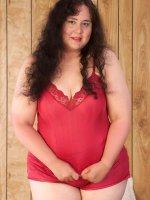 This bbw hottie is looking oh so naughty as she removes her red outfit